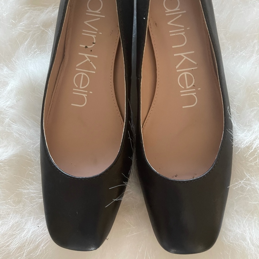 Black Calvin Klein flats.